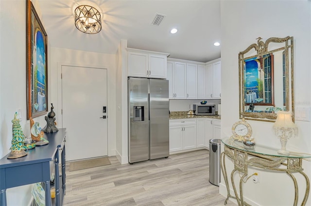 kitchen featuring stainless steel appliances, light wood finished floors, white cabinetry, visible vents, and recessed lighting