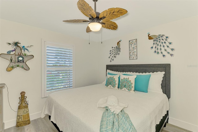 bedroom with baseboards, a ceiling fan, and wood finished floors