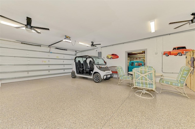 garage with a garage door opener and a ceiling fan