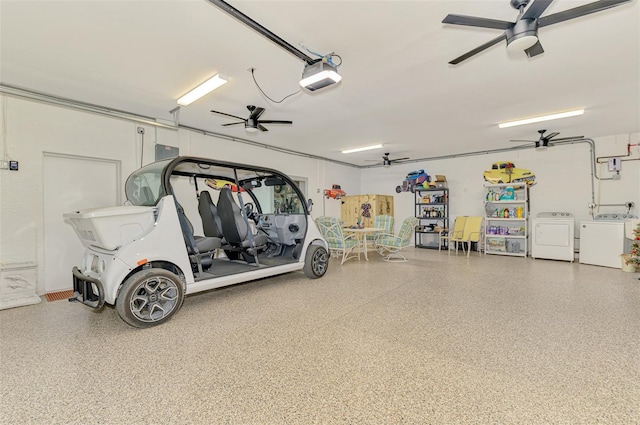 garage with a ceiling fan, independent washer and dryer, and a garage door opener