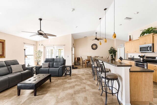 7089 Benson St, Englewood, FL 34224 - living room with vaulted ceiling, visible vents, and ceiling fan