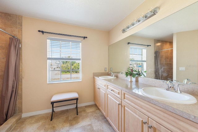 7089 Benson St, Englewood, FL 34224 - full bathroom featuring baseboards, a sink, double vanity, and tiled shower