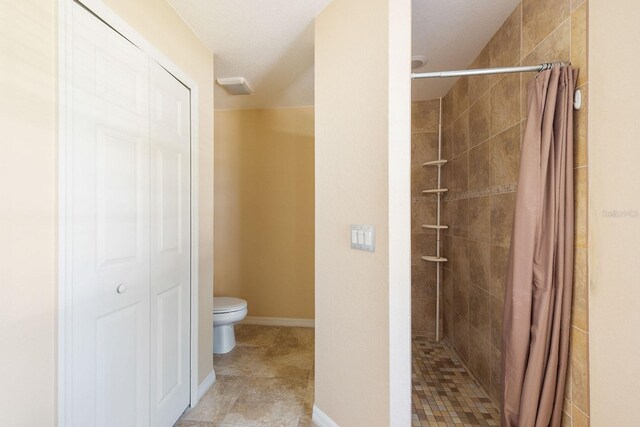 7089 Benson St, Englewood, FL 34224 - bathroom featuring toilet, a closet, and tiled shower