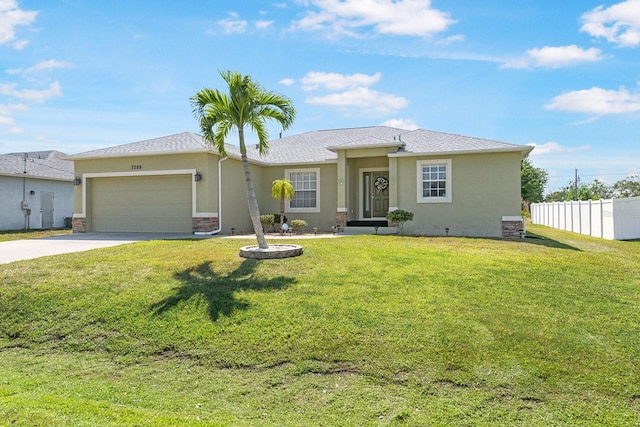 7089 Benson St, Englewood, FL 34224 - view of front of house with stucco siding, driveway, a garage, and fence