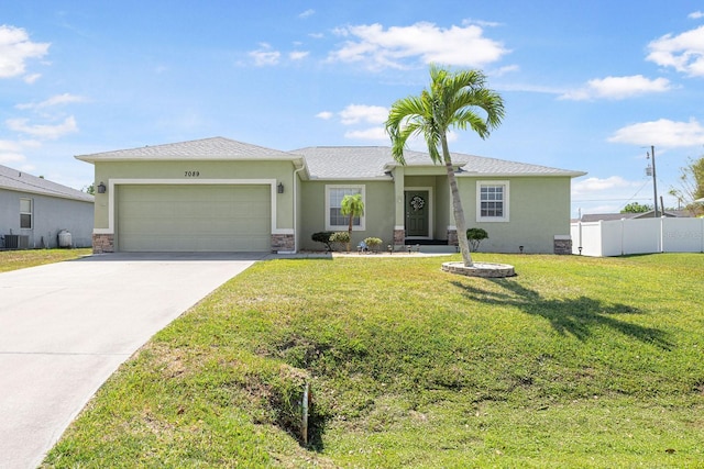 7089 Benson St, Englewood, FL 34224 - ranch-style house featuring a front lawn, concrete driveway, fence, an attached garage, and stucco siding