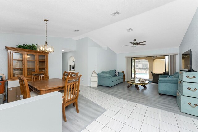 23347 Lehigh Ave, Port Charlotte, FL 33954 - dining room with ceiling fan with notable chandelier, vaulted ceiling, visible vents, and light tile patterned floors