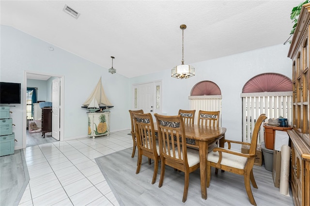 23347 Lehigh Ave, Port Charlotte, FL 33954 - dining area with lofted ceiling, visible vents, a wealth of natural light, and light tile patterned floors