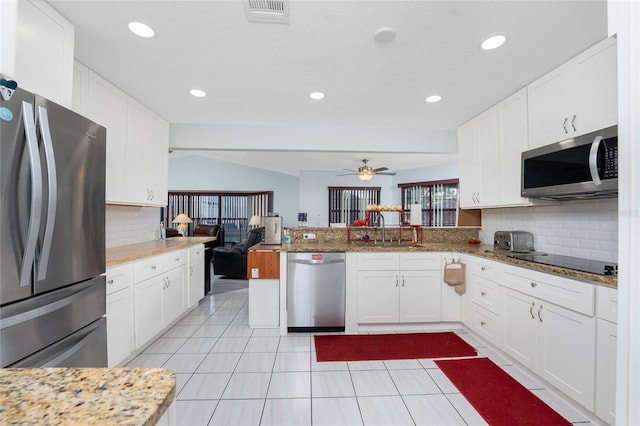 23347 Lehigh Ave, Port Charlotte, FL 33954 - kitchen with white cabinets, stainless steel appliances, visible vents, a sink, and tasteful backsplash