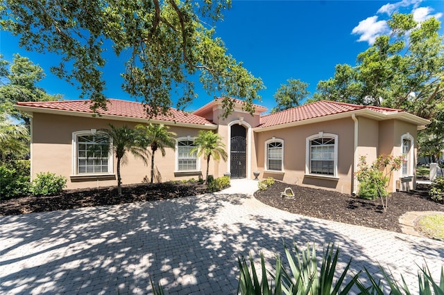 26 Saint Croix Way, Englewood, FL 34223 - mediterranean / spanish-style home with a tile roof and stucco siding