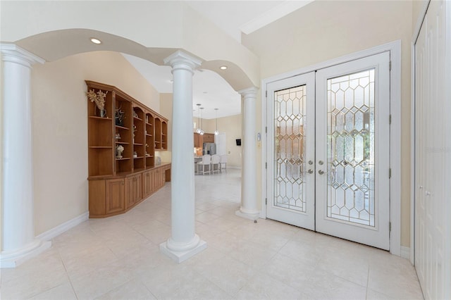 26 Saint Croix Way, Englewood, FL 34223 - foyer entrance with arched walkways, light tile patterned floors, french doors, and decorative columns