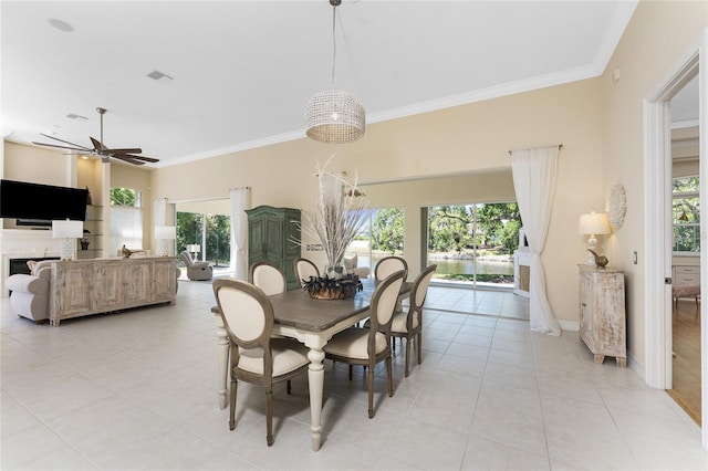 26 Saint Croix Way, Englewood, FL 34223 - dining room with a ceiling fan, visible vents, light tile patterned floors, and crown molding