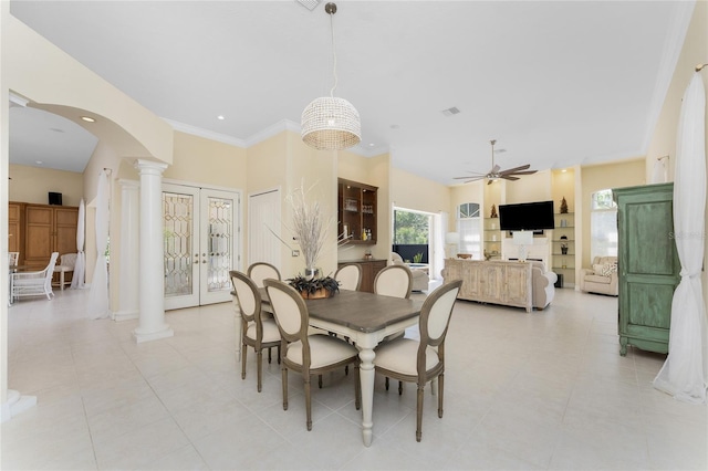 26 Saint Croix Way, Englewood, FL 34223 - dining space featuring a ceiling fan, ornamental molding, light tile patterned floors, arched walkways, and decorative columns
