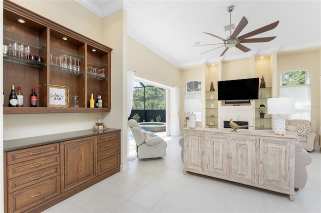 26 Saint Croix Way, Englewood, FL 34223 - living room featuring light tile patterned floors, ceiling fan, a fireplace, ornamental molding, and visible vents
