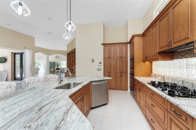 26 Saint Croix Way, Englewood, FL 34223 - kitchen with dishwasher, black gas cooktop, brown cabinetry, and a sink