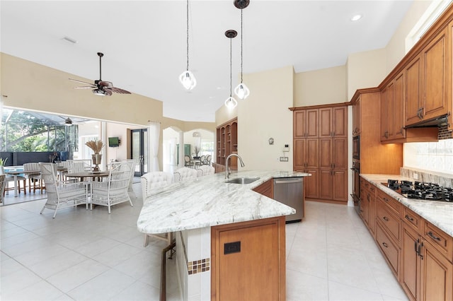 26 Saint Croix Way, Englewood, FL 34223 - kitchen with under cabinet range hood, a breakfast bar, dishwasher, a sink, and brown cabinetry