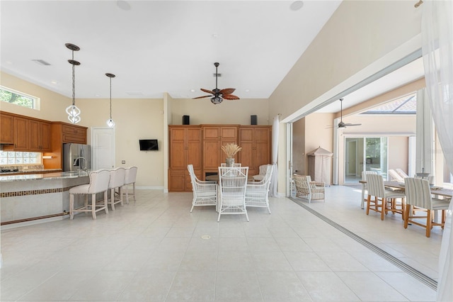 26 Saint Croix Way, Englewood, FL 34223 - dining space with ceiling fan, a high ceiling, visible vents, and light tile patterned floors