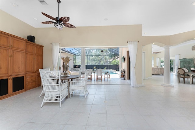 26 Saint Croix Way, Englewood, FL 34223 - dining space with arched walkways, light tile patterned flooring, visible vents, ornate columns, and a ceiling fan