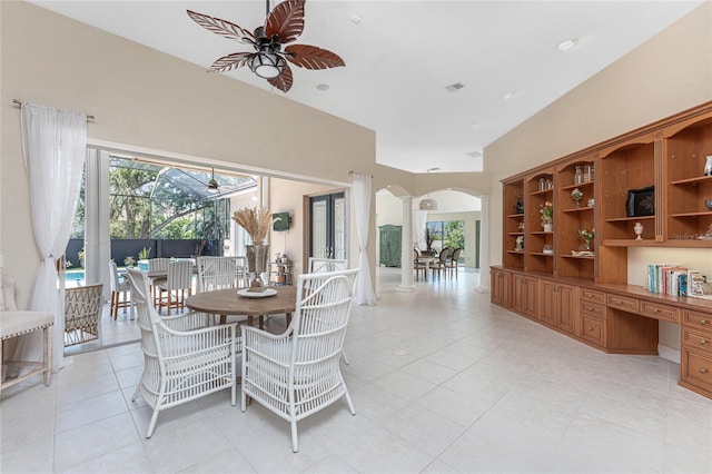 26 Saint Croix Way, Englewood, FL 34223 - dining room with arched walkways, light tile patterned flooring, ceiling fan, and decorative columns