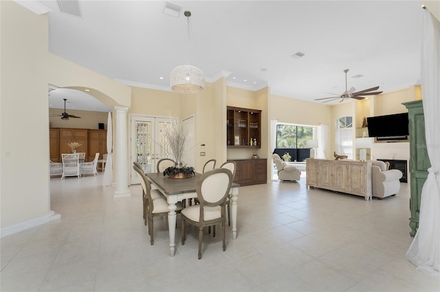 26 Saint Croix Way, Englewood, FL 34223 - dining area with a ceiling fan, arched walkways, a fireplace, visible vents, and ornate columns