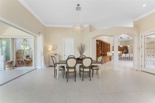 26 Saint Croix Way, Englewood, FL 34223 - dining area with arched walkways, ornamental molding, light tile patterned flooring, and ornate columns