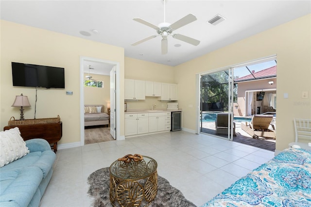 26 Saint Croix Way, Englewood, FL 34223 - living room with wine cooler, visible vents, light tile patterned floors, baseboards, and ceiling fan