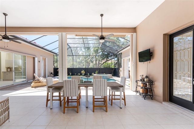 26 Saint Croix Way, Englewood, FL 34223 - dining space featuring a sunroom, a ceiling fan, and light tile patterned floors
