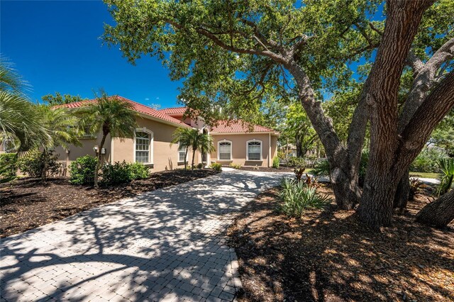 26 Saint Croix Way, Englewood, FL 34223 - mediterranean / spanish home featuring a tiled roof, decorative driveway, and stucco siding