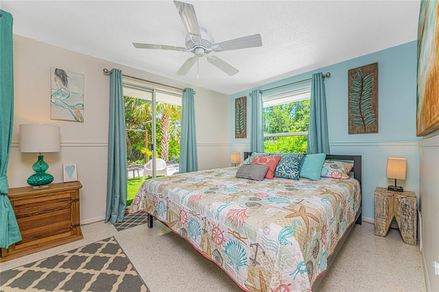 bedroom featuring speckled floor, baseboards, ceiling fan, and access to exterior