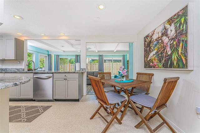 dining room featuring beamed ceiling, a wealth of natural light, recessed lighting, and baseboards