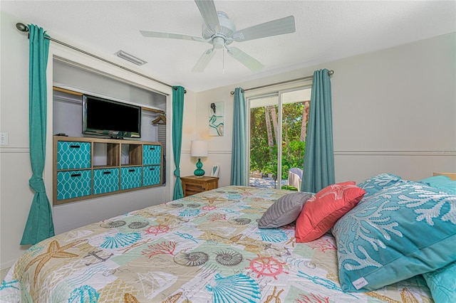 bedroom featuring visible vents, access to outside, a textured ceiling, and ceiling fan