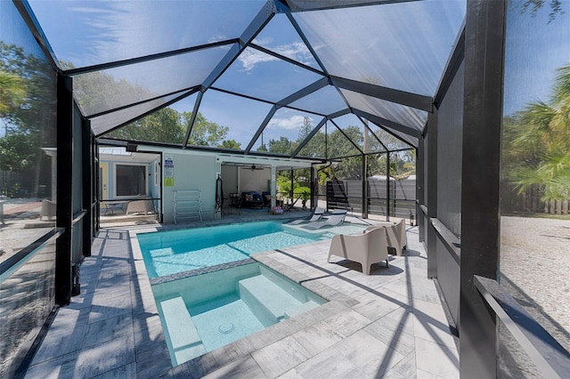 view of swimming pool with a patio area, a pool with connected hot tub, and a lanai
