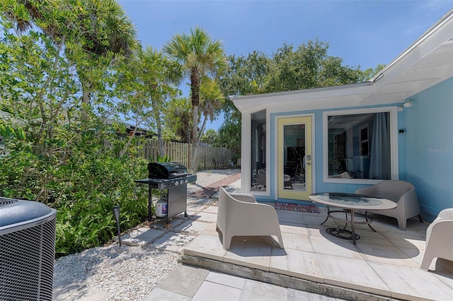 view of patio / terrace with grilling area, central AC unit, and fence