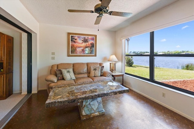 6305 Shalimar St, Port Charlotte, FL 33981 - living area featuring a textured ceiling, a water view, and a ceiling fan