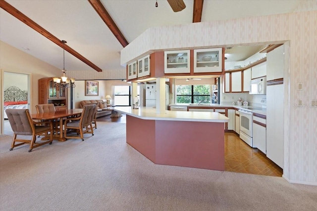 6305 Shalimar St, Port Charlotte, FL 33981 - kitchen with white appliances, wallpapered walls, light countertops, light carpet, and a chandelier