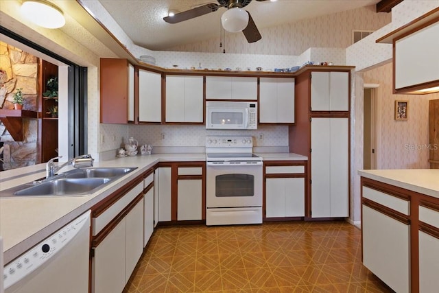 6305 Shalimar St, Port Charlotte, FL 33981 - kitchen featuring white appliances, wallpapered walls, light countertops, light flooring, and white cabinetry