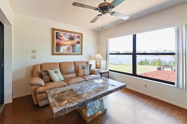 6305 Shalimar St, Port Charlotte, FL 33981 - living room featuring a water view, a textured ceiling, and a ceiling fan