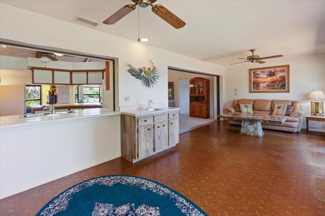 6305 Shalimar St, Port Charlotte, FL 33981 - living area featuring a ceiling fan and a textured ceiling