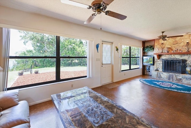 6305 Shalimar St, Port Charlotte, FL 33981 - living area featuring ceiling fan, a textured ceiling, and a stone fireplace
