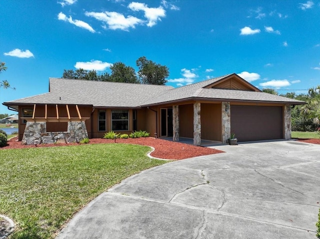 6305 Shalimar St, Port Charlotte, FL 33981 - single story home with stone siding, a garage, concrete driveway, and a front lawn