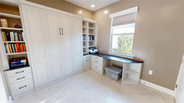 unfurnished office with recessed lighting and baseboards