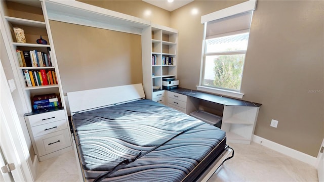 bedroom featuring light colored carpet and baseboards
