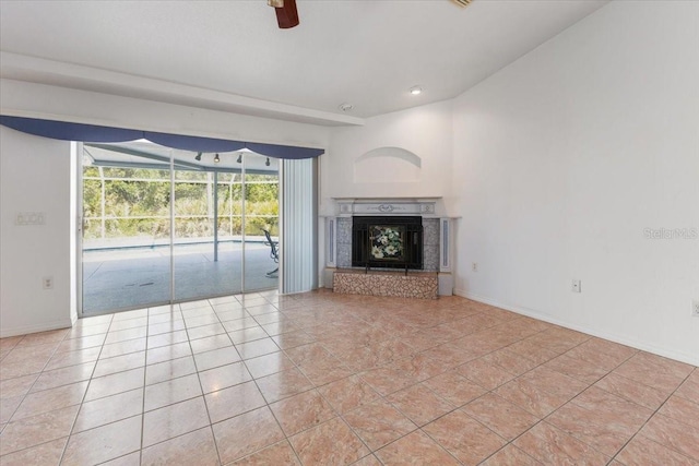unfurnished living room with baseboards, recessed lighting, ceiling fan, a tile fireplace, and light tile patterned floors