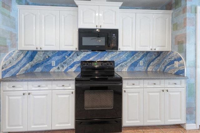 kitchen with decorative backsplash, light countertops, white cabinetry, and black appliances