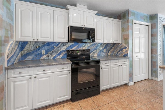 kitchen featuring white cabinets, light tile patterned floors, decorative backsplash, and black appliances