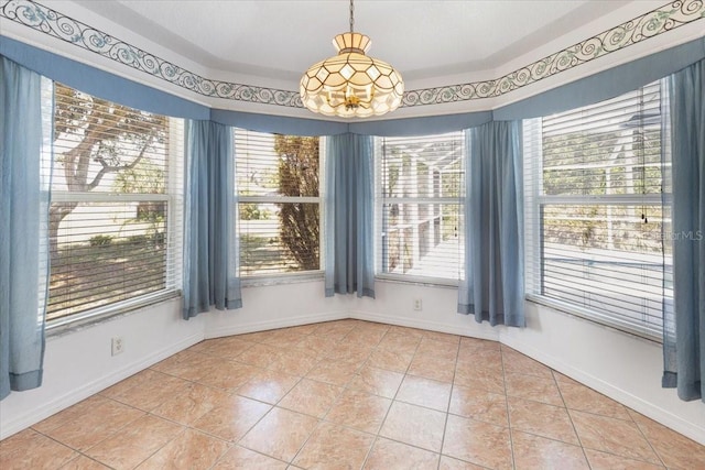 unfurnished dining area featuring a notable chandelier, baseboards, and light tile patterned flooring