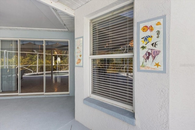 view of exterior entry featuring stucco siding