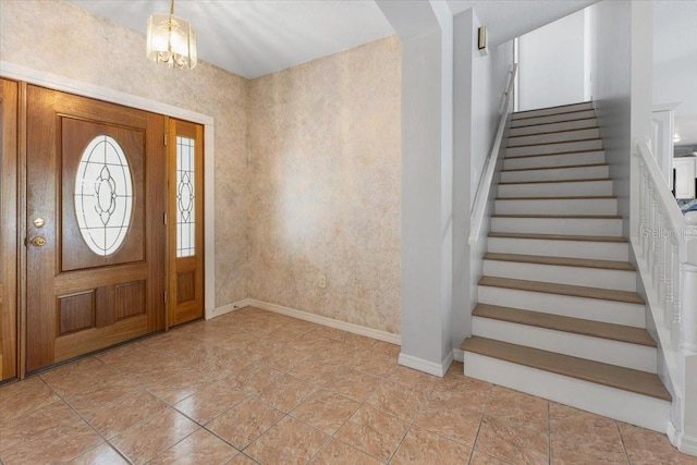 entrance foyer with baseboards and stairway