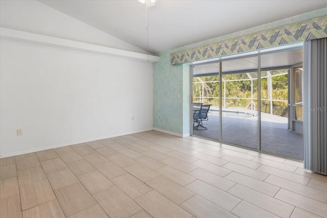 unfurnished room with lofted ceiling and baseboards