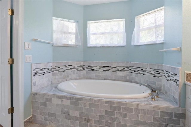 bathroom with a bath and a healthy amount of sunlight