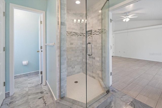 full bathroom with a shower stall, baseboards, and a ceiling fan